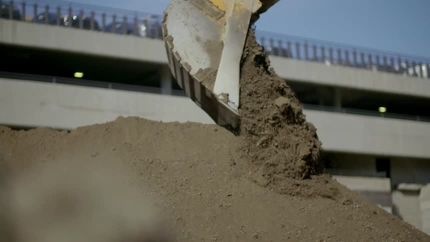 Dirt is dropped on a huge pile