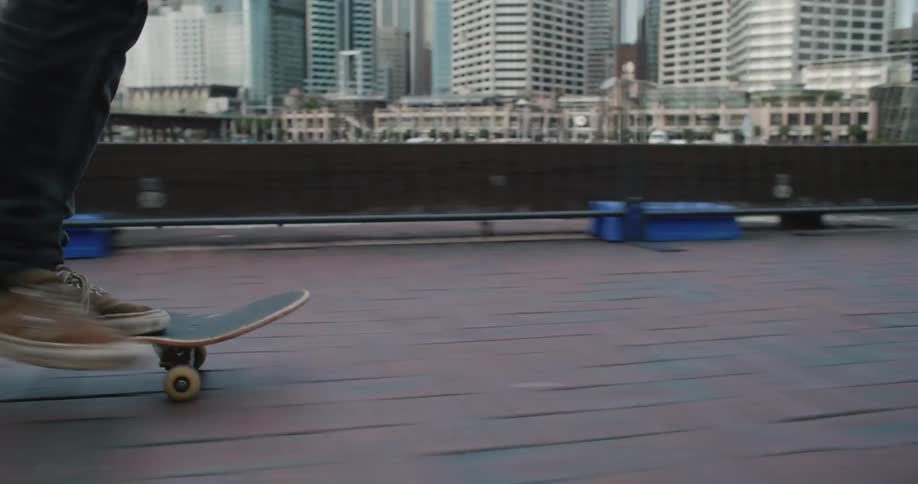 A person is skateboarding through a downtown city