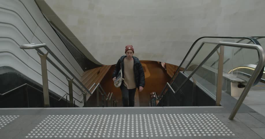 A man walking up a flight of stairs in a building