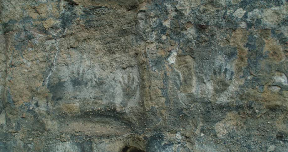 Images of hands on rocks