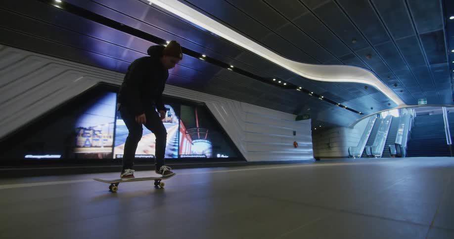 A man skateboarding in an underground tunnel