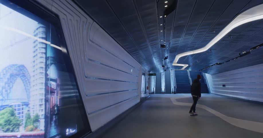 A man is skateboarding in a lobby of a building