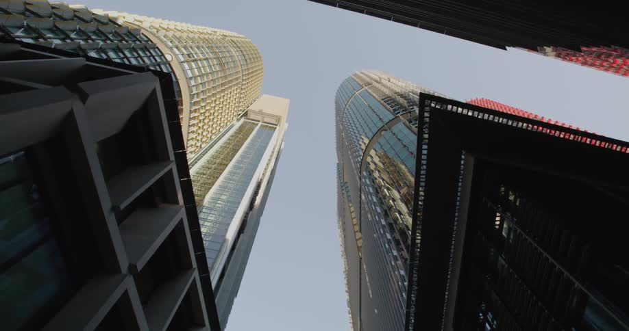 A view from below a downtown city is displayed