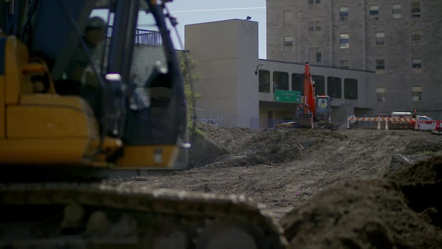 A man is driving an excavation vehicle