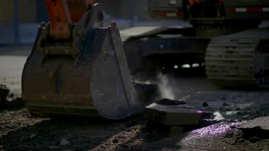 An excavation machine picks up debris