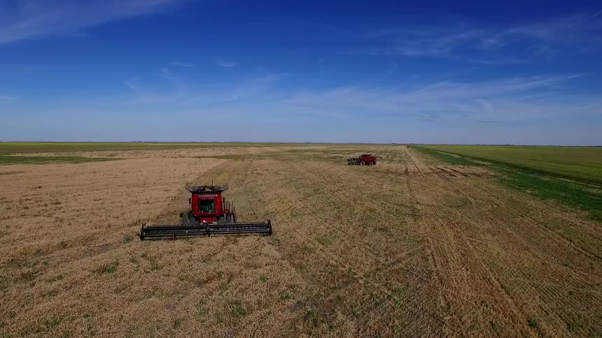 Large farm equipment moving across a field