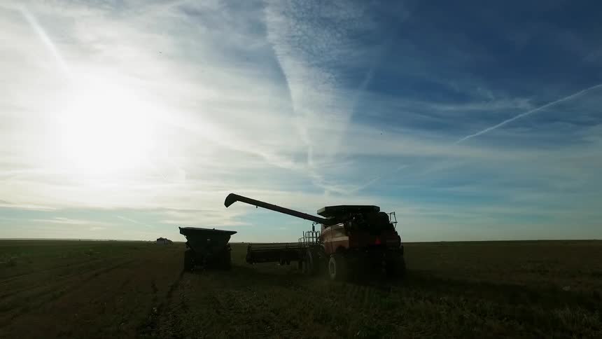 A farm vehicle sits still on a field