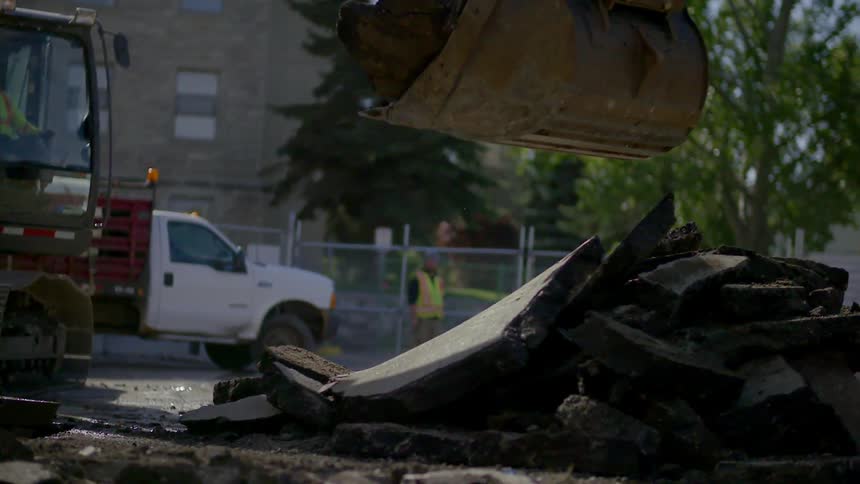 An excavation machine moves debris in work site
