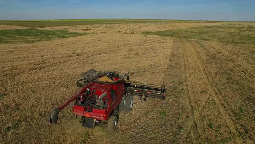 Aerial view of a farm vehicle working a field