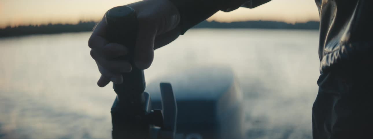 A person operating a motorboat steers it by using a steering rod