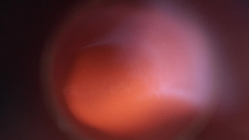 Red light comes on shining within halo effect in darkness