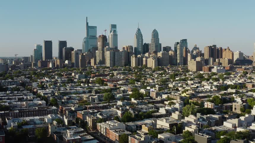 A city skyline with sprawling neighborhoods and streets in front