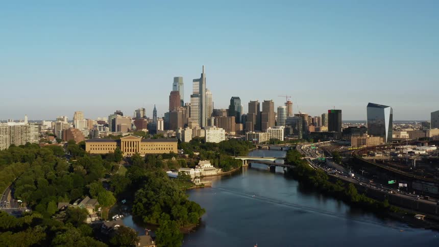 Aerial view of high rise buildings with river next to public park in Philadelphia