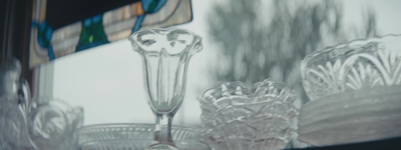 Glassware resting on a shelf near a window at home