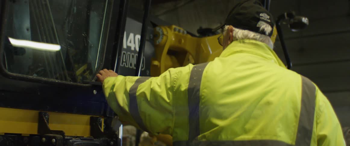 A man is getting into a truck at work