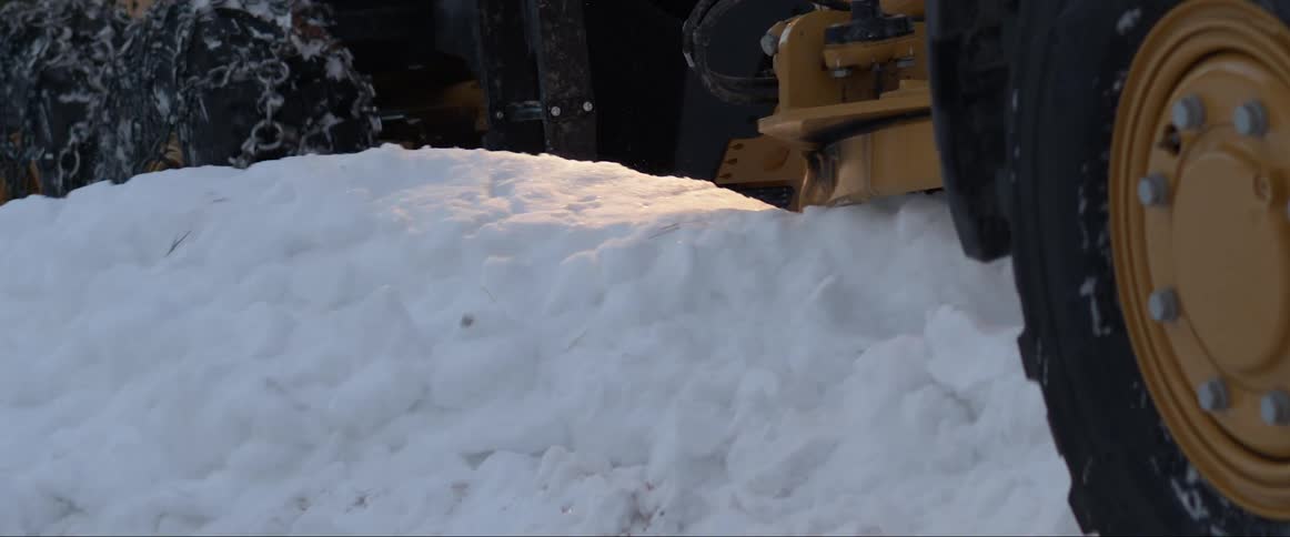 Snow removal vehicle clears road