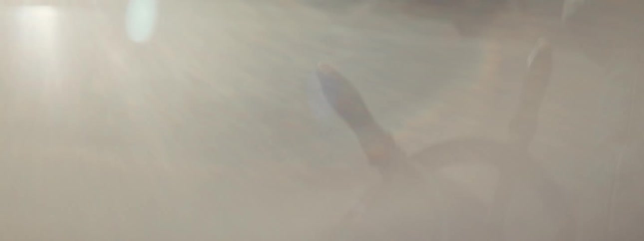 Man spinning a ship wheel in a boat at morning