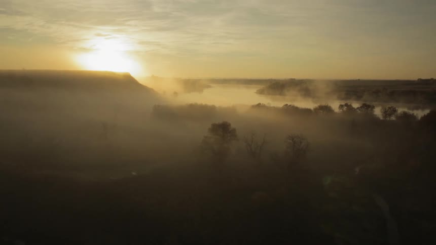 Aerial view of the sunrise over a golden mountain landscape