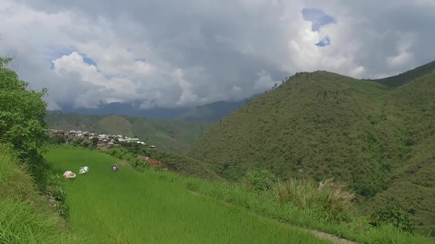 Aerial view of a green hillside on a cloudy day