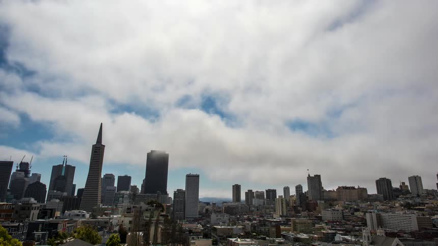 Time lapse of clouds moving over a large city
