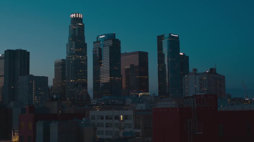 The buildings are lit up at sunset
