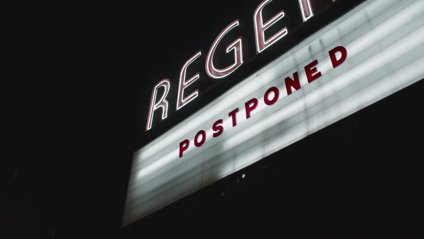 A lit up canceled sign on a theatre
