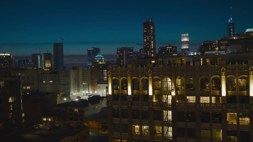 A city skyline with buildings with the sky and clouds in the background