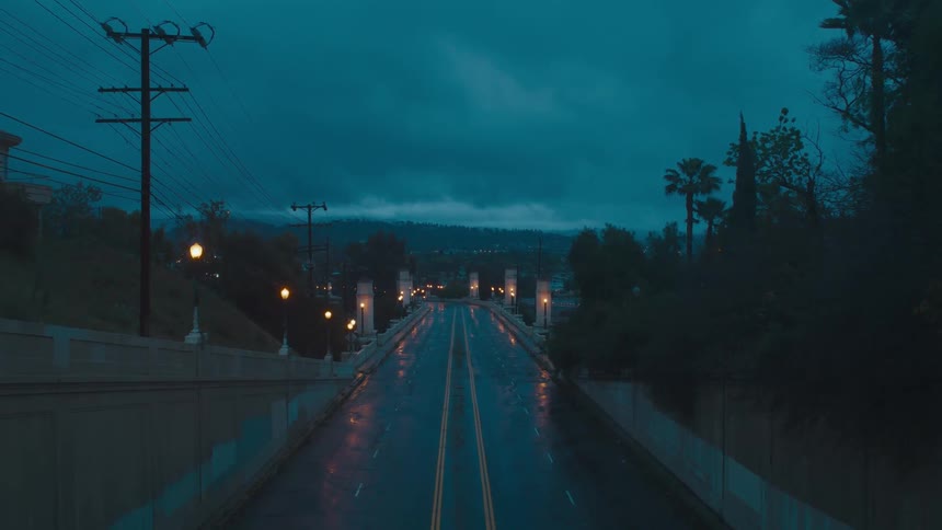 A view of a street at night after a rain