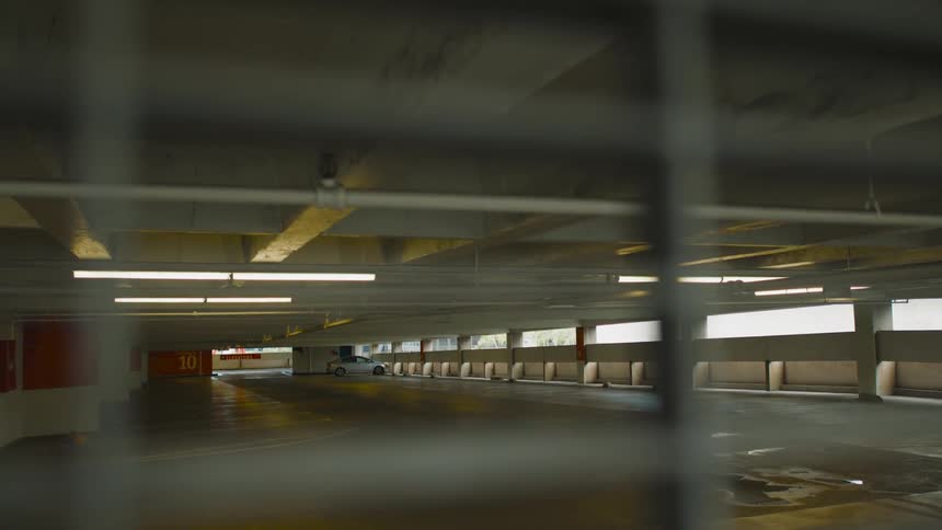 A view of a parking garage with one car in it