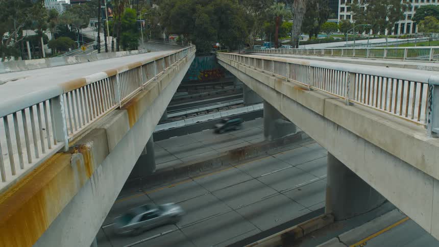 A view from between two small bridges with cars driving underneath