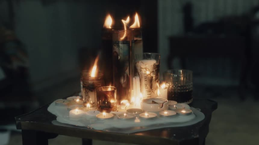 A group of candles are burning on the table