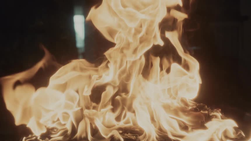Flames and smoke of a fire against a black background