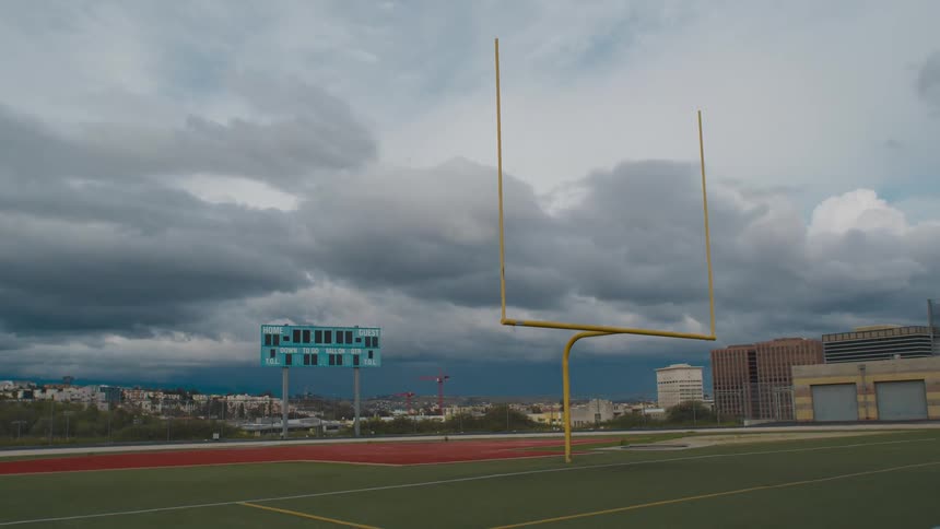 An empty football field is shown during the day in spring