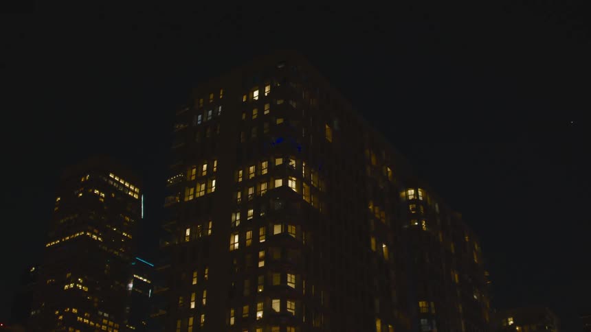 Aerial view of a downtown city is displayed at night