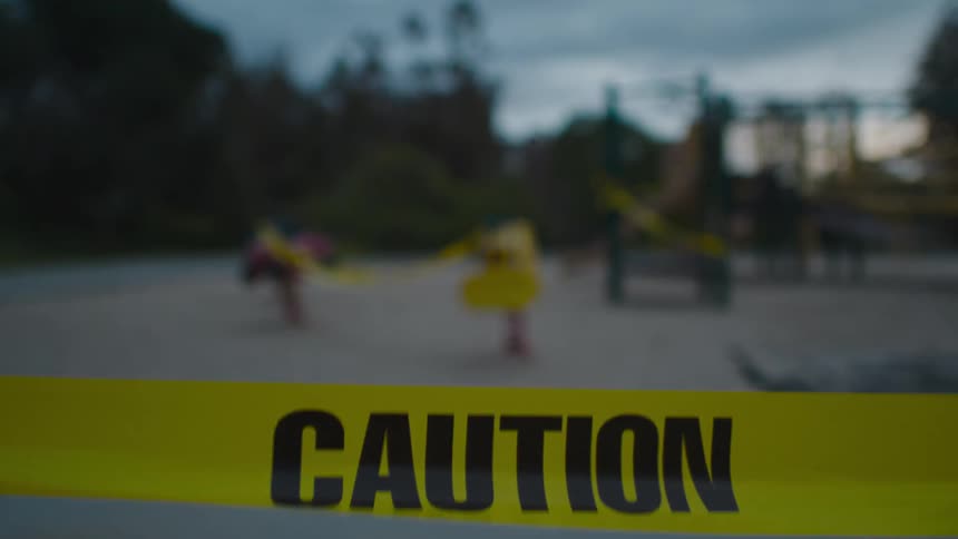 A look at a sandy public park taped up with caution sign