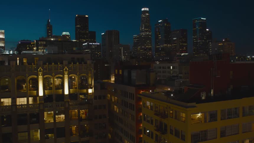 Night shot of a city with tall buildings visible at a distance