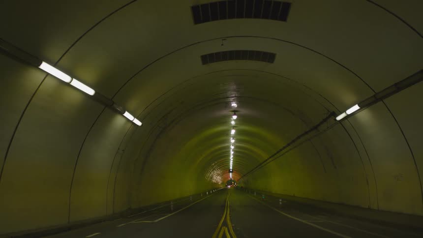 An empty tunnel with a street is displayed