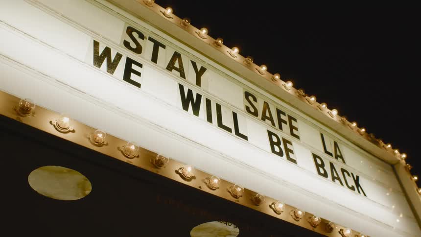 Lights blinking on an outdoor business sign at night