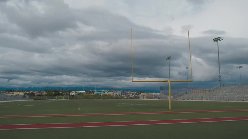 An empty football field is displayed in spring