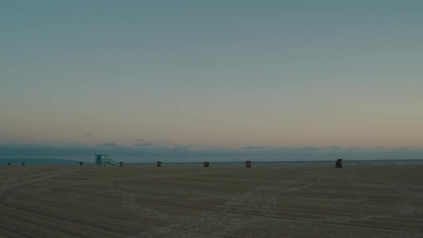 A lifeguard tower overlooks the ocean on a calm beach