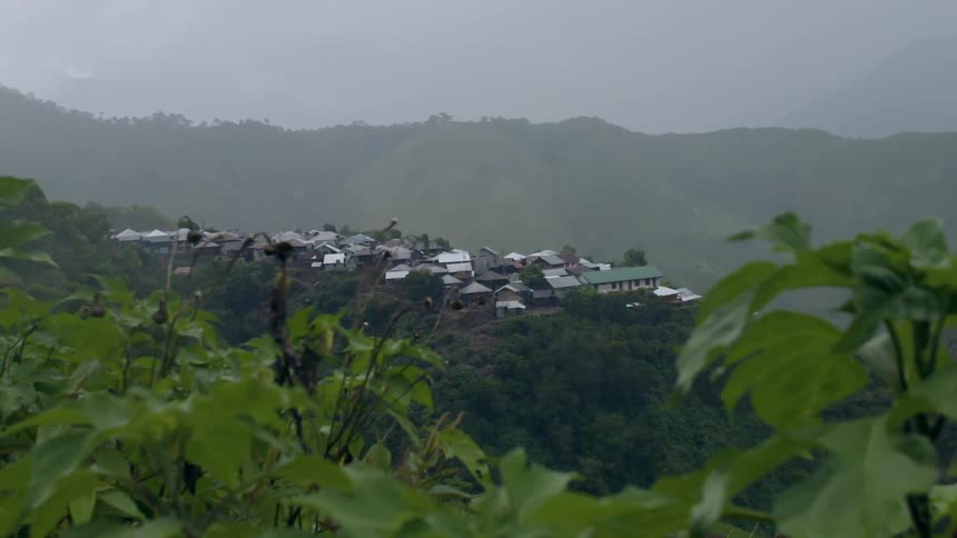 Rain falling in the wilderness with the view of a town in the distance