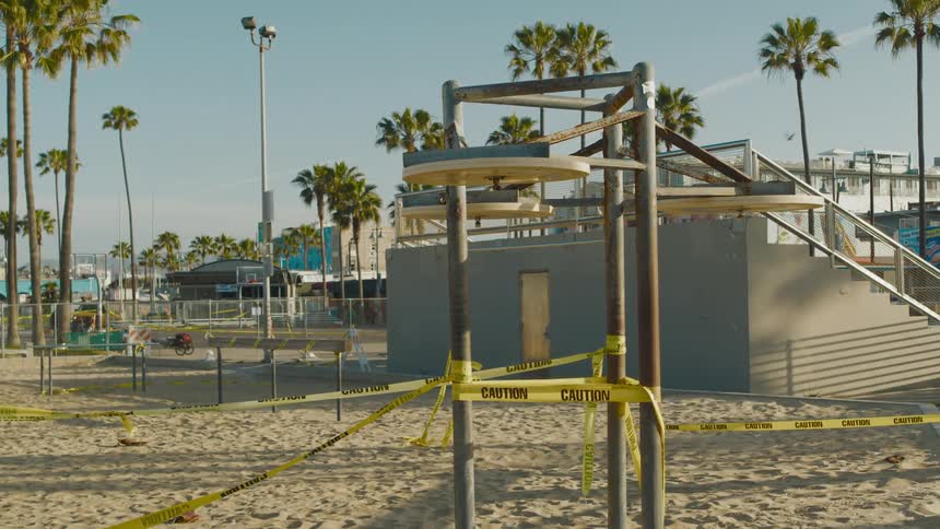 A view of a public sand area taped with caution sign