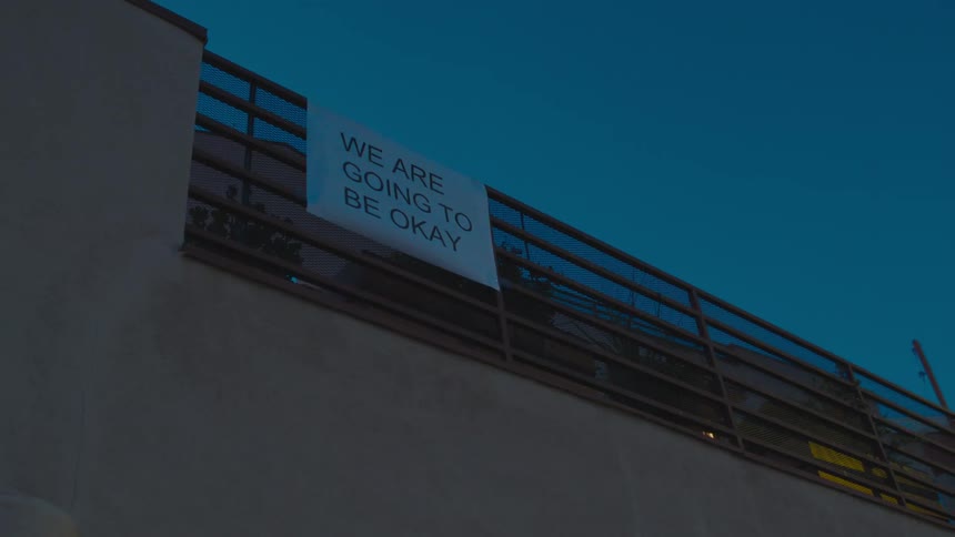 A view of a sign on a metal fence