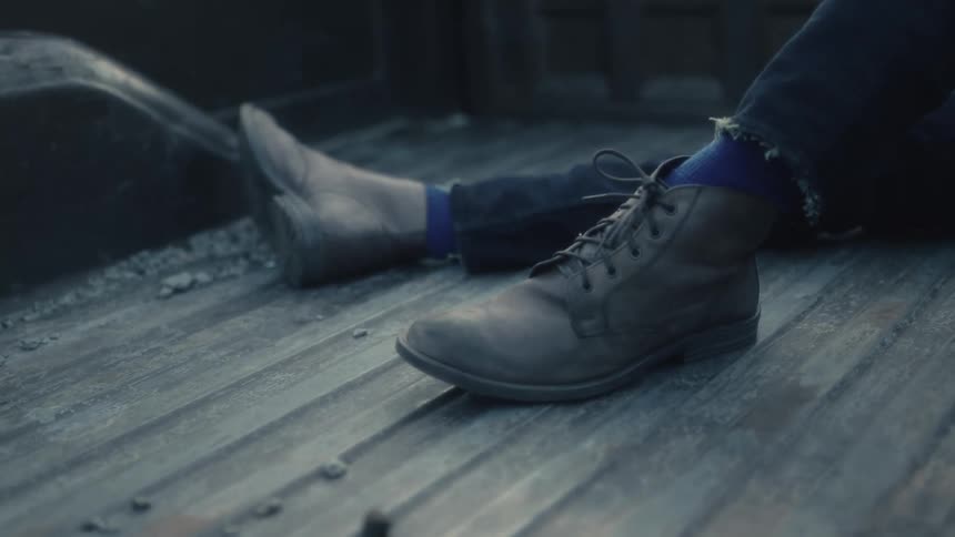 A man sitting in the bed of a truck