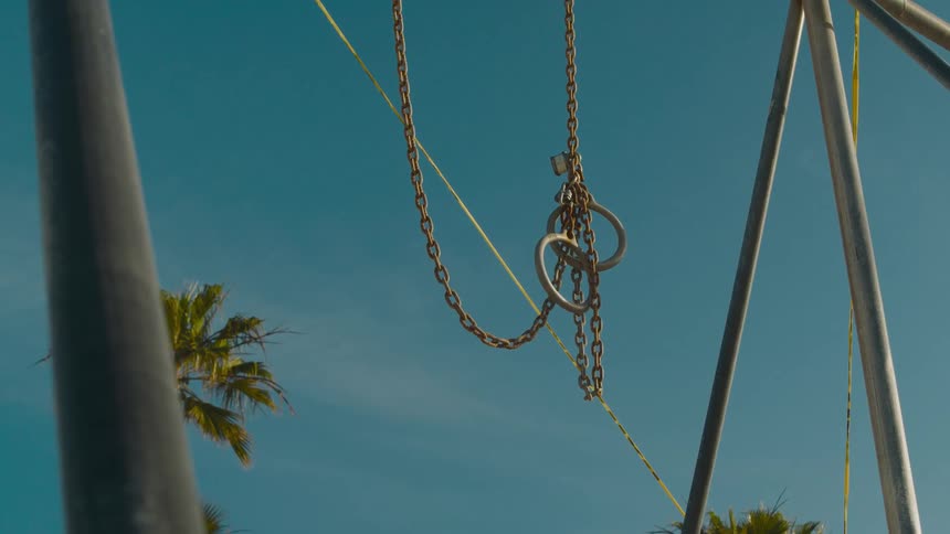 A chain is hanging from a pole outdoors