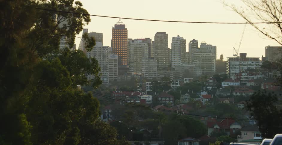 Wide shot of a city with multiple tall buildings visible at a distance