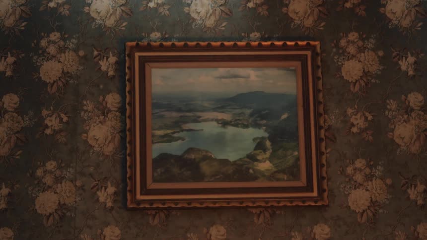 A fire is burning in front of a painting hanging on the wall