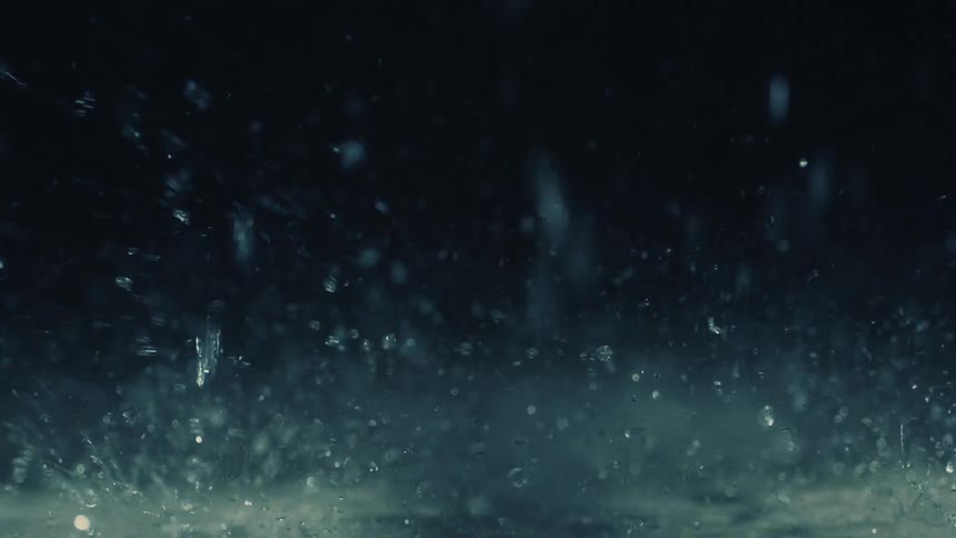 A view of rain drops falling at night