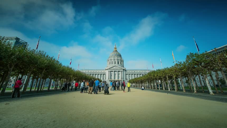 Time lapse of people walking in a square before a building