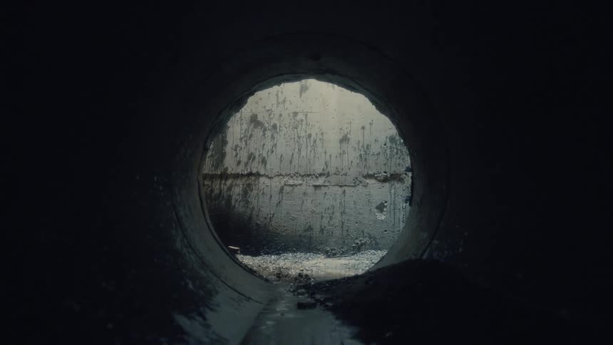A stream of water is flowing inside a tunnel